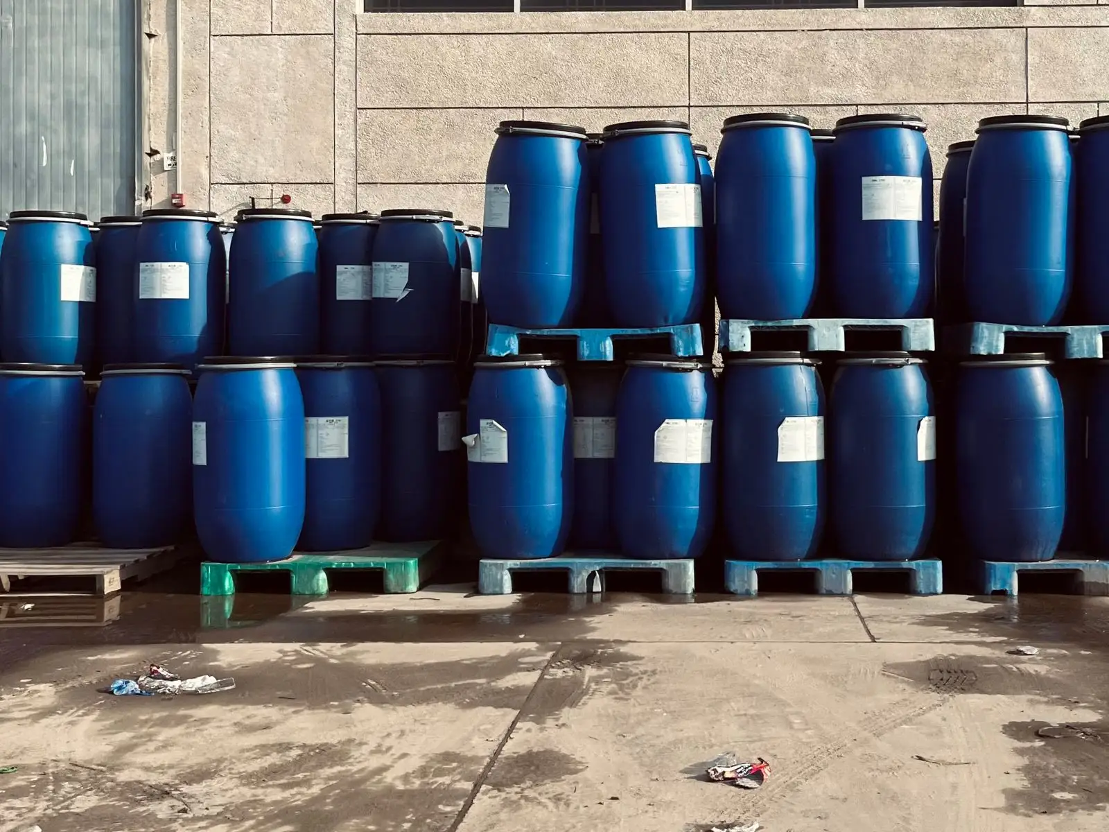 Industrial drums stacked on pallets in a warehouse