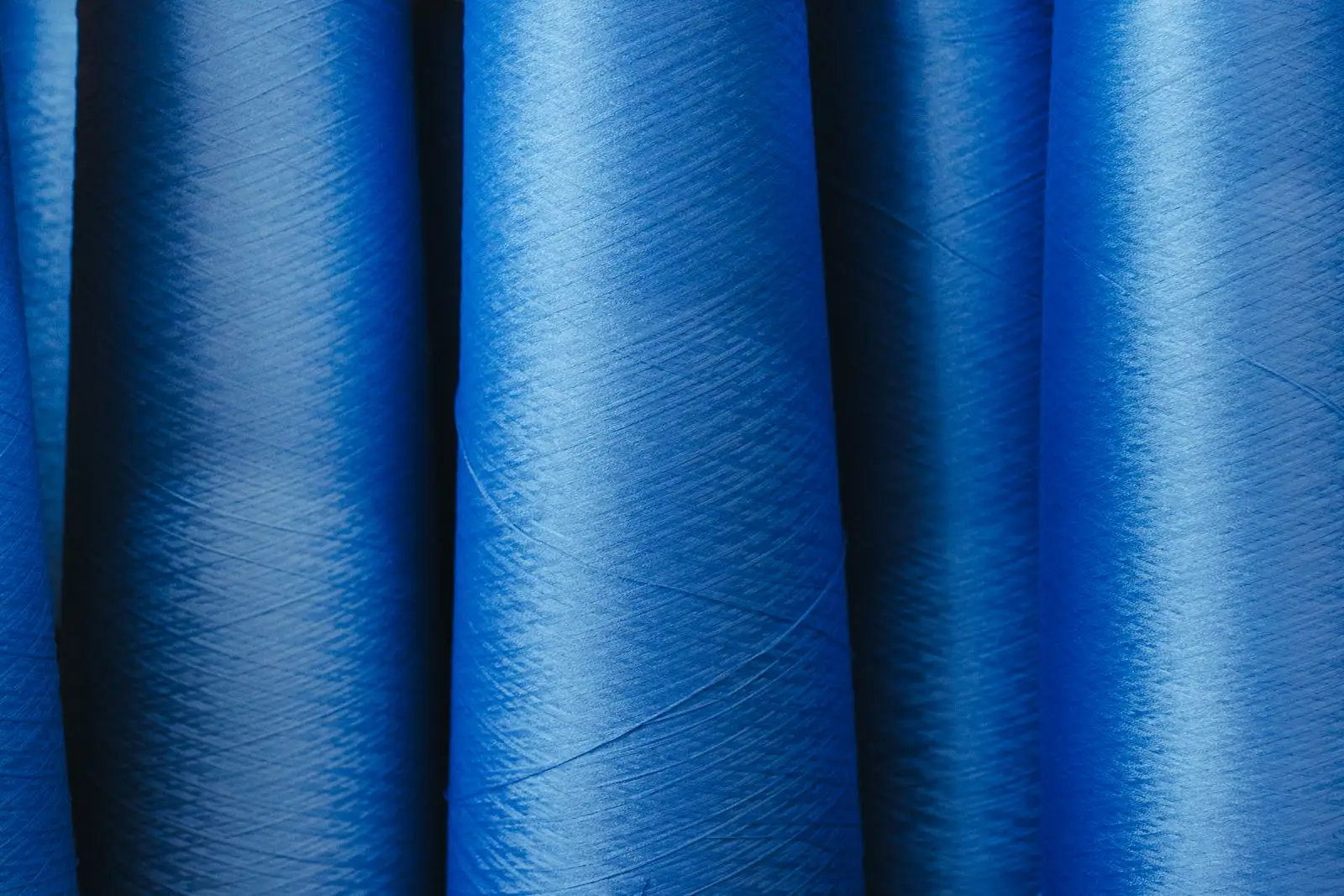 Rows of textile yarn spools